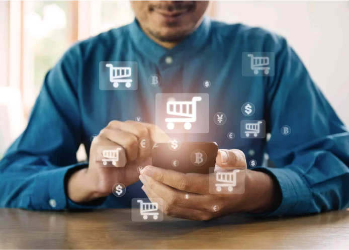A person using a smartphone surrounded by digital shopping cart icons, representing the growth of e-commerce and the increasing role of AI in online shopping experiences.