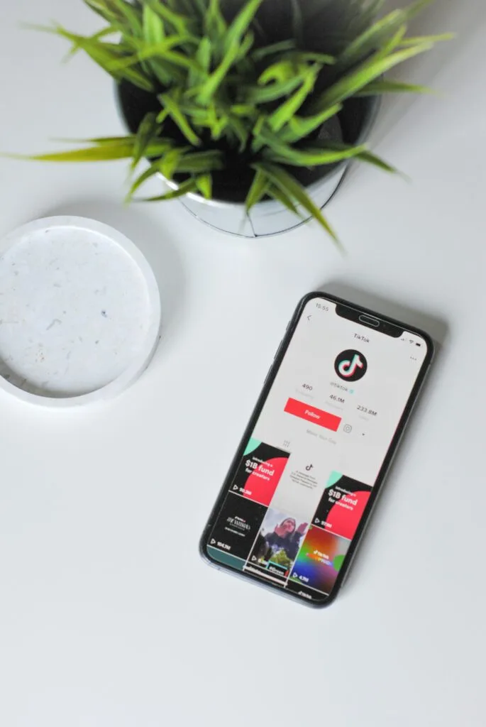 A smartphone displaying the TikTok app, showcasing trending eCommerce content. The image highlights the growing influence of TikTok eCommerce marketing, emphasizing key trends that enhance holiday sales and incorporate innovative AI strategies.