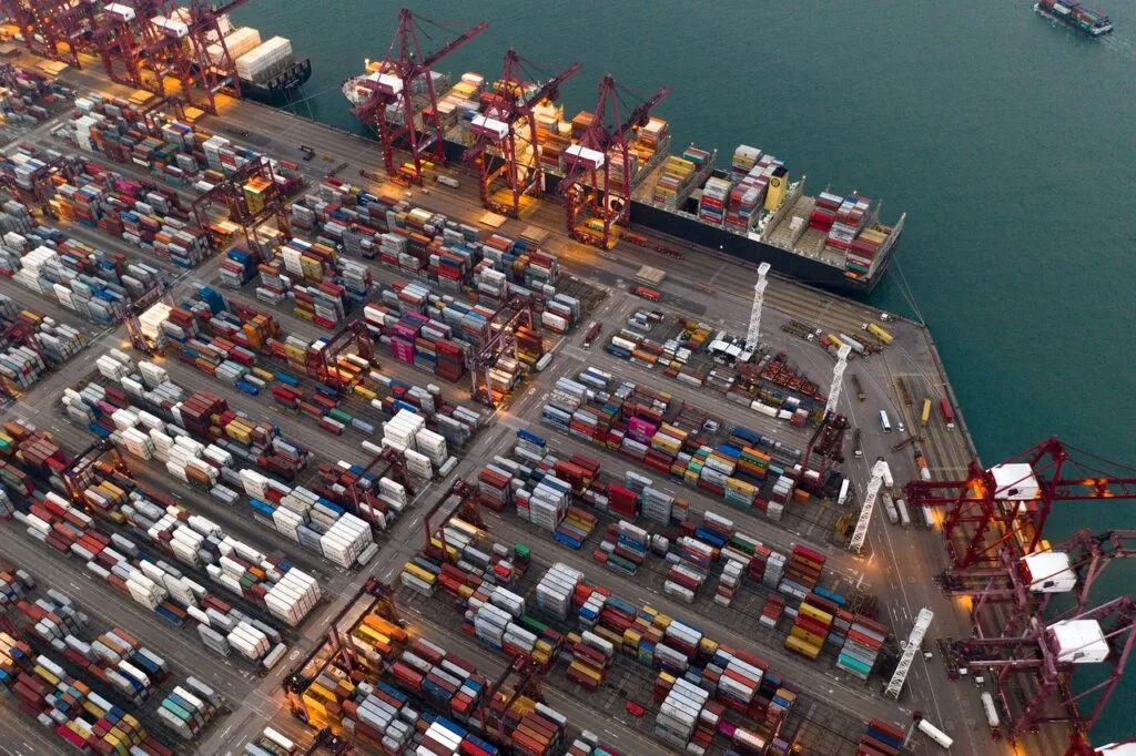 Containers on a shipyard, symbolizing the global logistics and supply chain dynamics influenced by the Amazon Haul strategy and the broader impacts of trade wars on eCommerce.