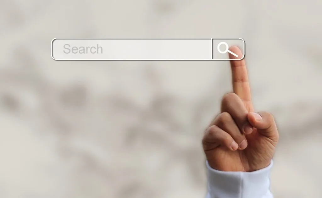 A search bar with a hand tapping on it, illustrating the role of dynamic search ads within the Amazon Haul strategy, transforming e-commerce experiences and driving targeted results.