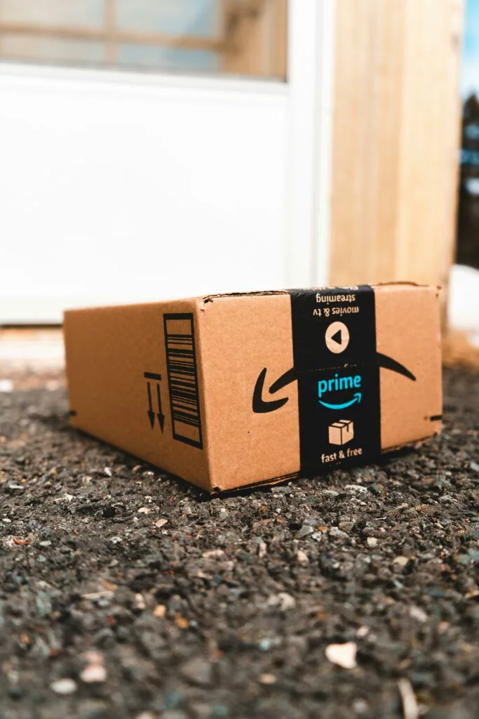 Amazon Prime package on the ground highlighting exclusive prime discounts for shoppers.