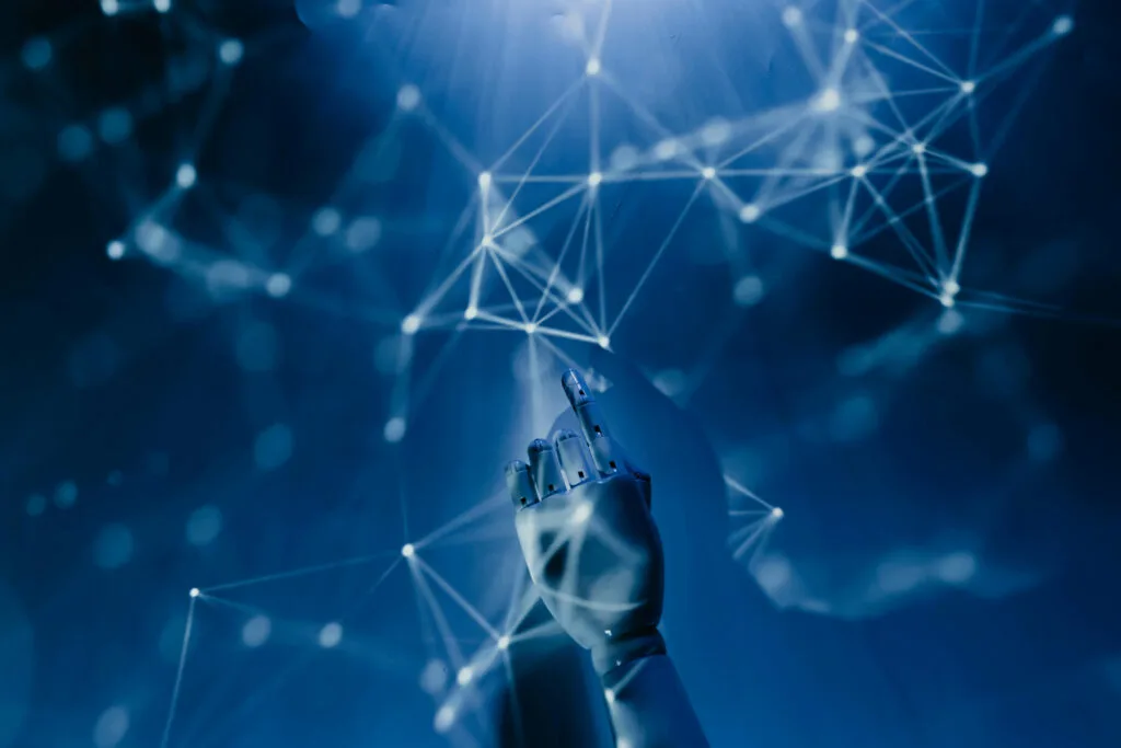 A robotic hand reaching towards a glowing network of interconnected nodes, symbolizing Amazon eCommerce strategies, automation, and real-time optimization in digital commerce.