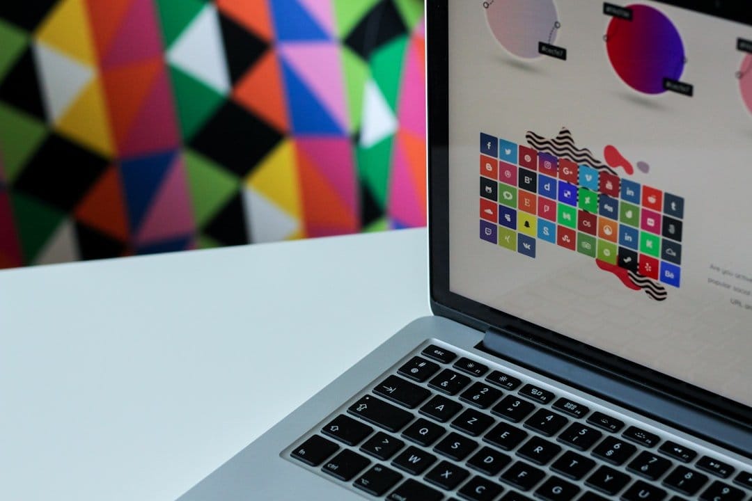 Laptop screen displaying design elements for a confirmation email template with colorful geometric background.