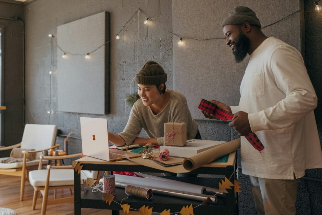 Image of people online shopping following a recent newsletter with email upsell tactics