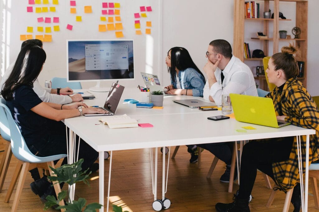 Group of eCommerce professionals discussing AI tools for Shopify