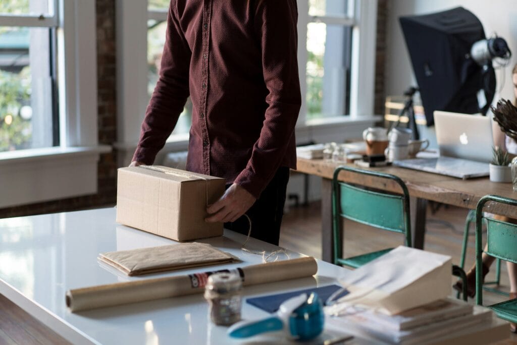 Image of a package being made ready for shipment following a customer placing a new order in an update product page that implement visual hierarchy in eCommerce