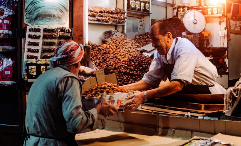 Image of a man selling their product to a woman, showcasing the voice of the Customer Initiatives