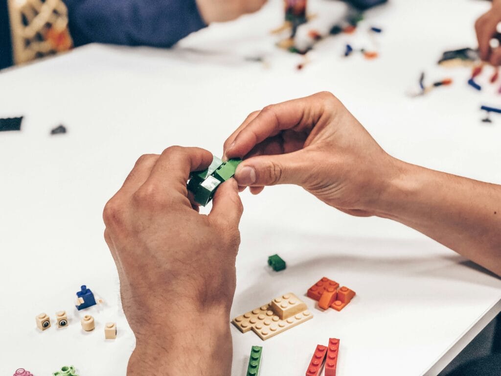 Image of person using Lego blocks to showcase gamification in eCommerce