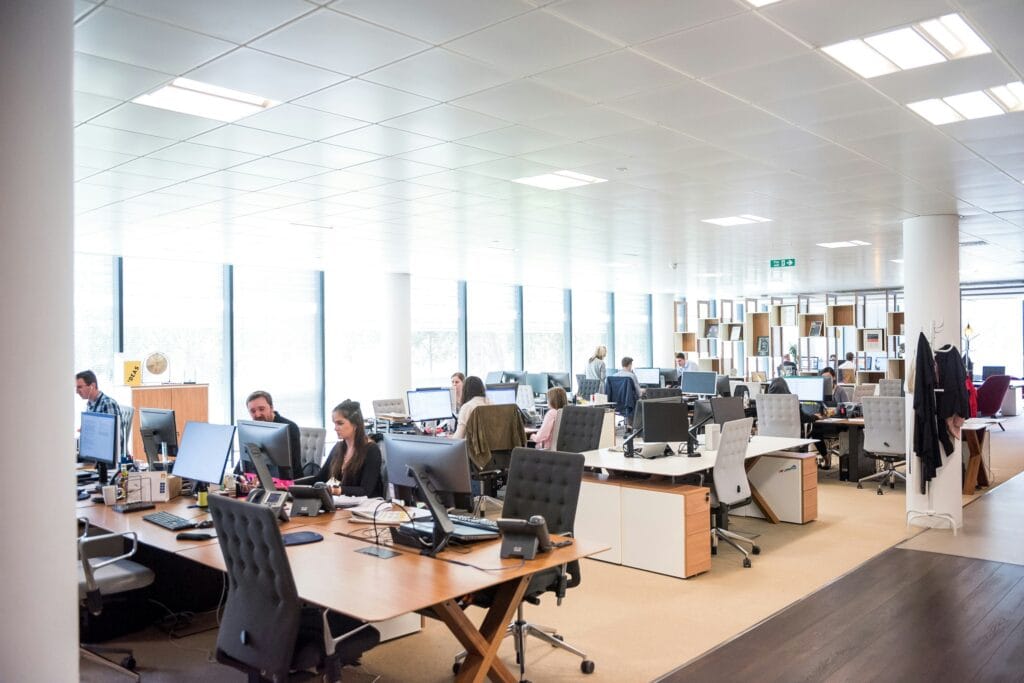 Image of a busy office dealing with high-ticket eCommerce with different team taking on scroll depth strategies