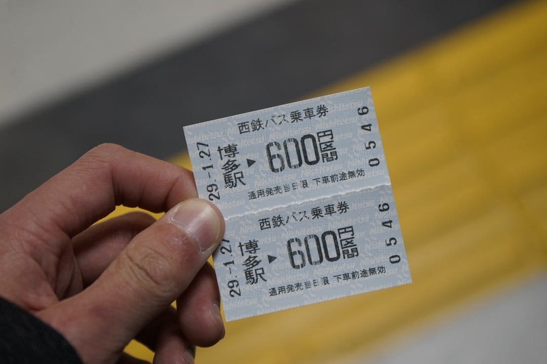 Hand holding train tickets, illustrating attention to detail, akin to how Scroll Depth in high-ticket eCommerce ensures needed information is accessible.