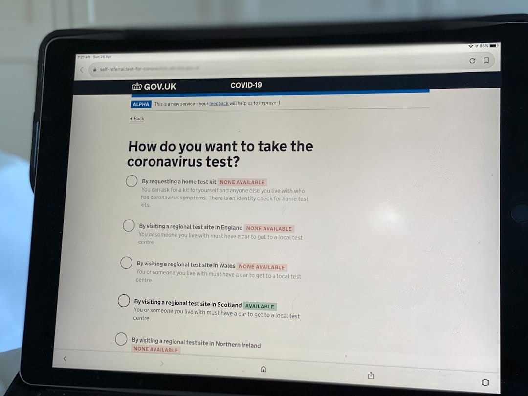 A tablet displaying a GOV.UK digital service on COVID-19 testing options, highlighting user interface and engagement.