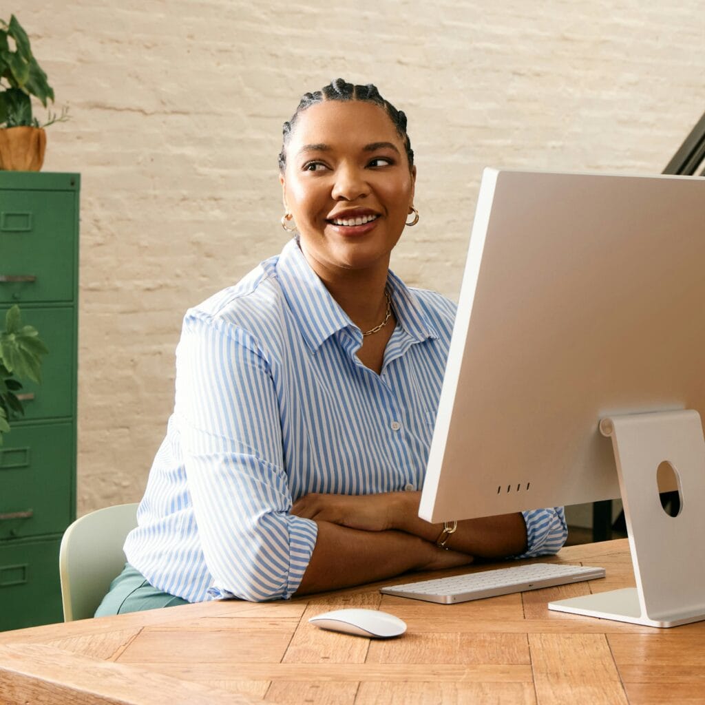 Picture of woman on her computer working on Order Confirmation Sales strategy