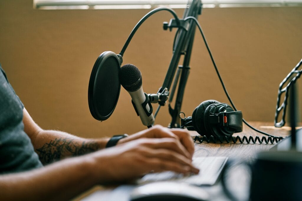 Professional podcasting setup discussing eCommerce news and Black Friday retail strategies with microphone and monitors