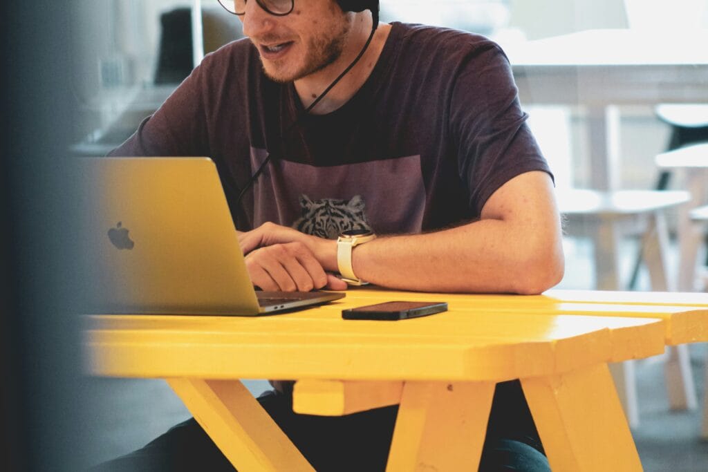 Image of person working on the computer with headsets on handling Order Confirmation Sales Boost implementation
